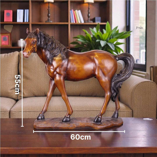 A glossy brown horse figurine standing on a matching base, placed on a wooden table in front of a beige sofa and bookshelf. White measurement lines with text show 55 cm height and 60 cm width.


