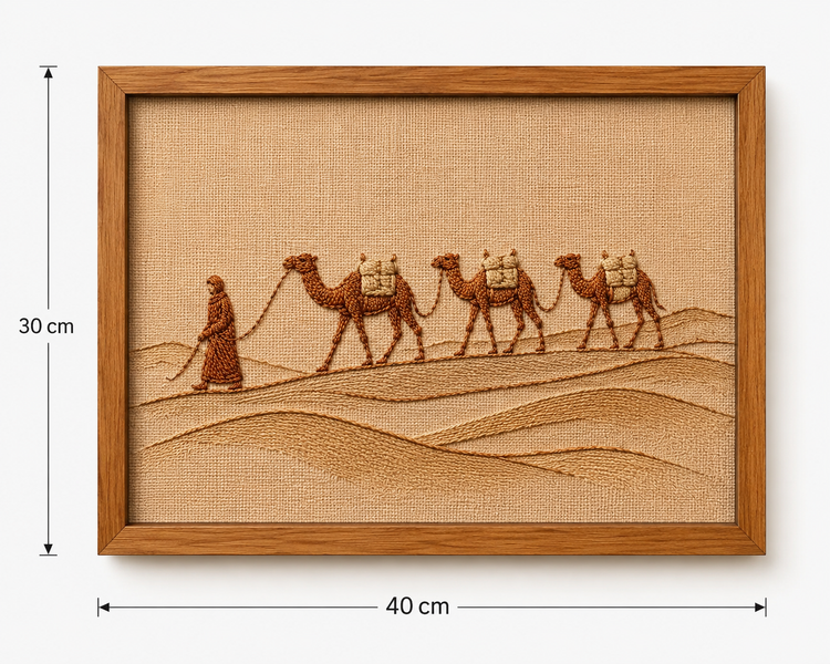 Framed embroidered desert scene artwork showing a caravan of camels and a shepherd on a tan fabric background, with dimension markers indicating 30 cm height and 40 cm width.


