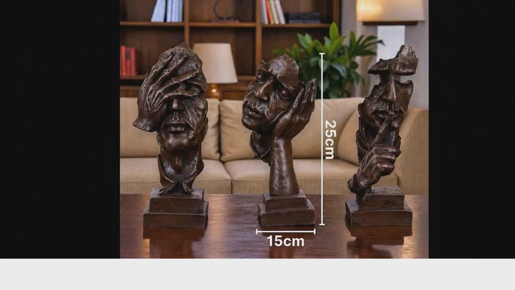 Three bronze sculptures on a marble coffee table in a living room setting.

